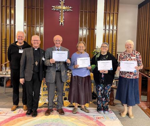 people holding certificates