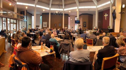 people sitting at Synod meeting