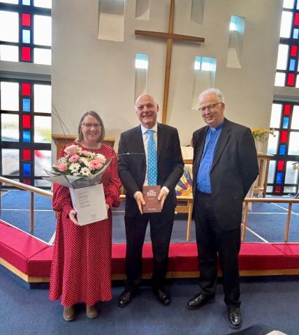 Kevin and his wife Helen receive gifts from The Revd David Miller (right)